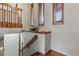 Well-lit hallway with wood accents and natural light, creating a warm and inviting transition space at 8170 Lt William Clark Rd, Parker, CO 80134