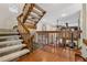 Open hallway featuring wooden staircase with natural light and views into the adjacent living space at 8170 Lt William Clark Rd, Parker, CO 80134