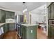 A well-lit kitchen with granite countertops, a center island, stainless steel appliances, and wooden floors at 8170 Lt William Clark Rd, Parker, CO 80134