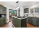 A sunlit kitchen with dark green cabinets, stainless steel appliances and access to the back deck at 8170 Lt William Clark Rd, Parker, CO 80134