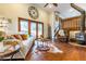 Cozy living room with a wood-burning stove, comfortable seating, and beautiful hardwood floors at 8170 Lt William Clark Rd, Parker, CO 80134