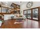 Inviting living room featuring hardwood floors, a vaulted ceiling, a large clock and natural light at 8170 Lt William Clark Rd, Parker, CO 80134