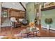 Inviting living room with wood stove, hardwood flooring, and wooden staircase at 8170 Lt William Clark Rd, Parker, CO 80134