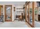 A home office with natural light, built-in shelves, and a desk near a door to the outside patio at 8170 Lt William Clark Rd, Parker, CO 80134