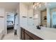 Bright bathroom featuring modern fixtures, white countertops, and a decorative light fixture at 1489 W 171St Pl, Broomfield, CO 80023