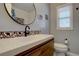 Modern bathroom with decorative tiling, a sleek vanity, and stylish fixtures at 3133 S Gaylord St, Englewood, CO 80113