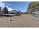 Community playground with exercise equipment, a mulch bed and apartment homes in the distance at 3133 S Gaylord St, Englewood, CO 80113