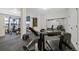 Home gym features ample workout space, mirrors, rubber flooring and natural light at 9 Mule Deer Trl, Littleton, CO 80127