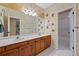 Bathroom featuring a double vanity, decorative Colorado mural, and separate tub/shower at 9 Mule Deer Trl, Littleton, CO 80127