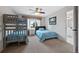 Cozy bedroom with a bunk bed, twin bed, and a view of the outdoors at 9 Mule Deer Trl, Littleton, CO 80127