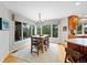 Breakfast nook with a wood table, seating for six, and natural light with views of the trees at 9 Mule Deer Trl, Littleton, CO 80127