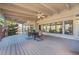 Inviting covered patio with a dining table, ceiling fans, and large windows overlooking the scenic view at 9 Mule Deer Trl, Littleton, CO 80127