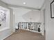 Upstairs hallway featuring a decorative railing overlooking the dining room below at 9 Mule Deer Trl, Littleton, CO 80127