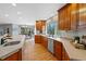 Spacious kitchen featuring wood cabinets, stainless steel appliances, and a view into the breakfast nook at 9 Mule Deer Trl, Littleton, CO 80127