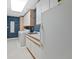 Well-equipped laundry room with modern appliances, a utility sink, and cabinetry at 9 Mule Deer Trl, Littleton, CO 80127