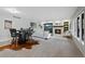 Open living room with a fireplace, TV, bar seating, and bright windows at 9 Mule Deer Trl, Littleton, CO 80127