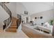 Open living room with a view, adjacent to a curved staircase at 9 Mule Deer Trl, Littleton, CO 80127