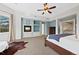 Spacious main bedroom featuring a fireplace, ceiling fan, and a large window with natural light at 9 Mule Deer Trl, Littleton, CO 80127