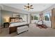 Spacious main bedroom with a sitting area, a large window, and an ensuite bathroom at 9 Mule Deer Trl, Littleton, CO 80127