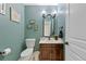 Charming powder room featuring a vanity with modern fixtures and decorative wall art at 9 Mule Deer Trl, Littleton, CO 80127
