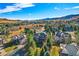 Gorgeous rear exterior of the home with a covered patio, large deck, and beautifully landscaped yard at 9 Mule Deer Trl, Littleton, CO 80127