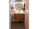 Nicely renovated bathroom with modern fixtures, a round mirror, and neutral tones at 3701 S Grant St, Englewood, CO 80113