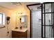 Modern bathroom featuring a glass-enclosed shower with sleek black hardware and stylish vanity at 3701 S Grant St, Englewood, CO 80113