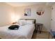 Calm and inviting bedroom with a cozy bed and a circular mirror adding style to the room at 3701 S Grant St, Englewood, CO 80113
