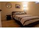 Cozy bedroom featuring a queen-size bed with striped bedding and a stylish round mirror at 3701 S Grant St, Englewood, CO 80113