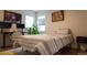 Sunlit bedroom with modern art above the bed and two windows illuminating the space at 3701 S Grant St, Englewood, CO 80113