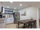 Well-lit kitchen with stainless steel appliances, white cabinets, and open shelving at 3701 S Grant St, Englewood, CO 80113