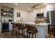 Modern kitchen with stainless steel appliances, island seating, and ample cabinet space at 3701 S Grant St, Englewood, CO 80113