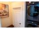 Modern laundry room with front-load washer and dryer adjacent to a charming wall art piece at 3701 S Grant St, Englewood, CO 80113