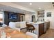 Open concept living room with fireplace, TV, dining area, and island with seating at 3701 S Grant St, Englewood, CO 80113