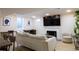 Cozy living space with a fireplace, TV, and dining area under recessed lighting at 3701 S Grant St, Englewood, CO 80113