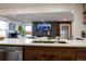 Open concept kitchen and living room with island seating, a modern fireplace and a TV at 3701 S Grant St, Englewood, CO 80113