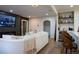 Comfortable living room with fireplace, large screen TV, and bar area with stools and shelves at 3701 S Grant St, Englewood, CO 80113