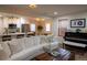 Bright open-concept living room and kitchen with hardwood floors and modern white furniture at 3701 S Grant St, Englewood, CO 80113