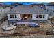 Aerial view of backyard with outdoor kitchen, spacious deck, and fire pit area at 9521 Garnett Way, Arvada, CO 80007