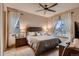 This bedroom features a ceiling fan, neutral decor, and lots of natural light at 9521 Garnett Way, Arvada, CO 80007