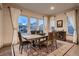 Elegant dining room featuring large windows, stylish furniture, and a warm ambiance for memorable gatherings at 9521 Garnett Way, Arvada, CO 80007