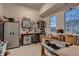 Organized garage featuring ample storage, workbench, and natural light from arched window at 9521 Garnett Way, Arvada, CO 80007