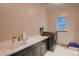 Laundry room with sink and dark wood cabinets and a large washer and dryer at 9521 Garnett Way, Arvada, CO 80007