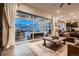 Living room featuring large sliding glass doors that lead to outdoor patio at 9521 Garnett Way, Arvada, CO 80007