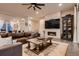 Living room featuring a modern fireplace and large flatscreen television at 9521 Garnett Way, Arvada, CO 80007