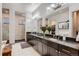 Bathroom featuring dual sinks, granite countertops, and stand-up glass shower at 9521 Garnett Way, Arvada, CO 80007