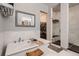 Bathroom featuring a tub, stand up shower, and a view into the walk-in closet at 9521 Garnett Way, Arvada, CO 80007