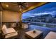 Covered outdoor patio features a grill, bar, seating, and string lights overhead at 9521 Garnett Way, Arvada, CO 80007