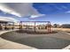 Community playground with swings, seating, and safety surfacing for Gathering fun at 9521 Garnett Way, Arvada, CO 80007