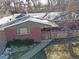 Aerial view of brick home showcasing mature trees, manicured yard, and inviting front entrance at 1004 W Shepperd Ave, Littleton, CO 80120